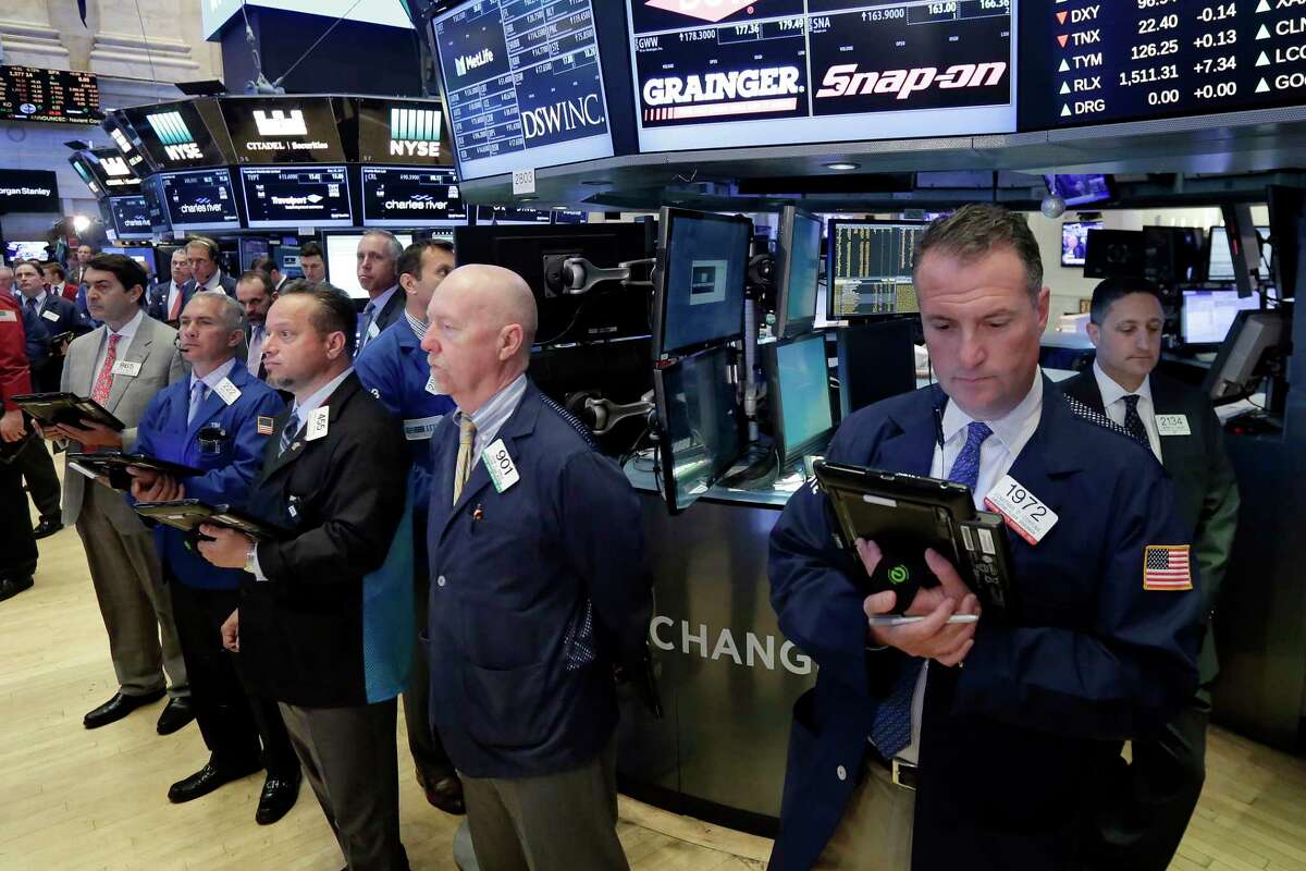 Traders on the floor of the New York Stock Exchange, Tuesday, May 23, 2017, observe a moment of silence in the wake of the attack in Manchester, England. (AP Photo/Richard Drew)