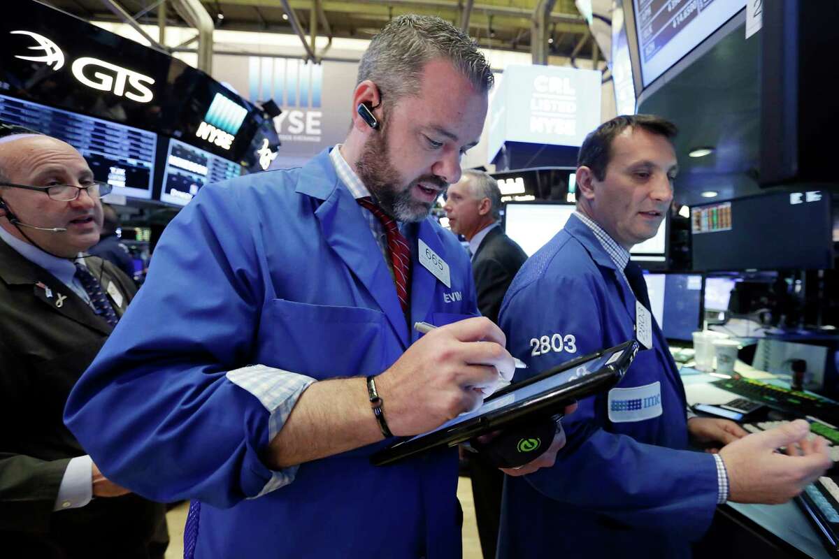 Trader Kevin Lodewick, center, works on the floor of the New York Stock Exchange, Tuesday, May 23, 2017. Stocks are opening slightly higher on Wall Street as technology companies post more gains. (AP Photo/Richard Drew)