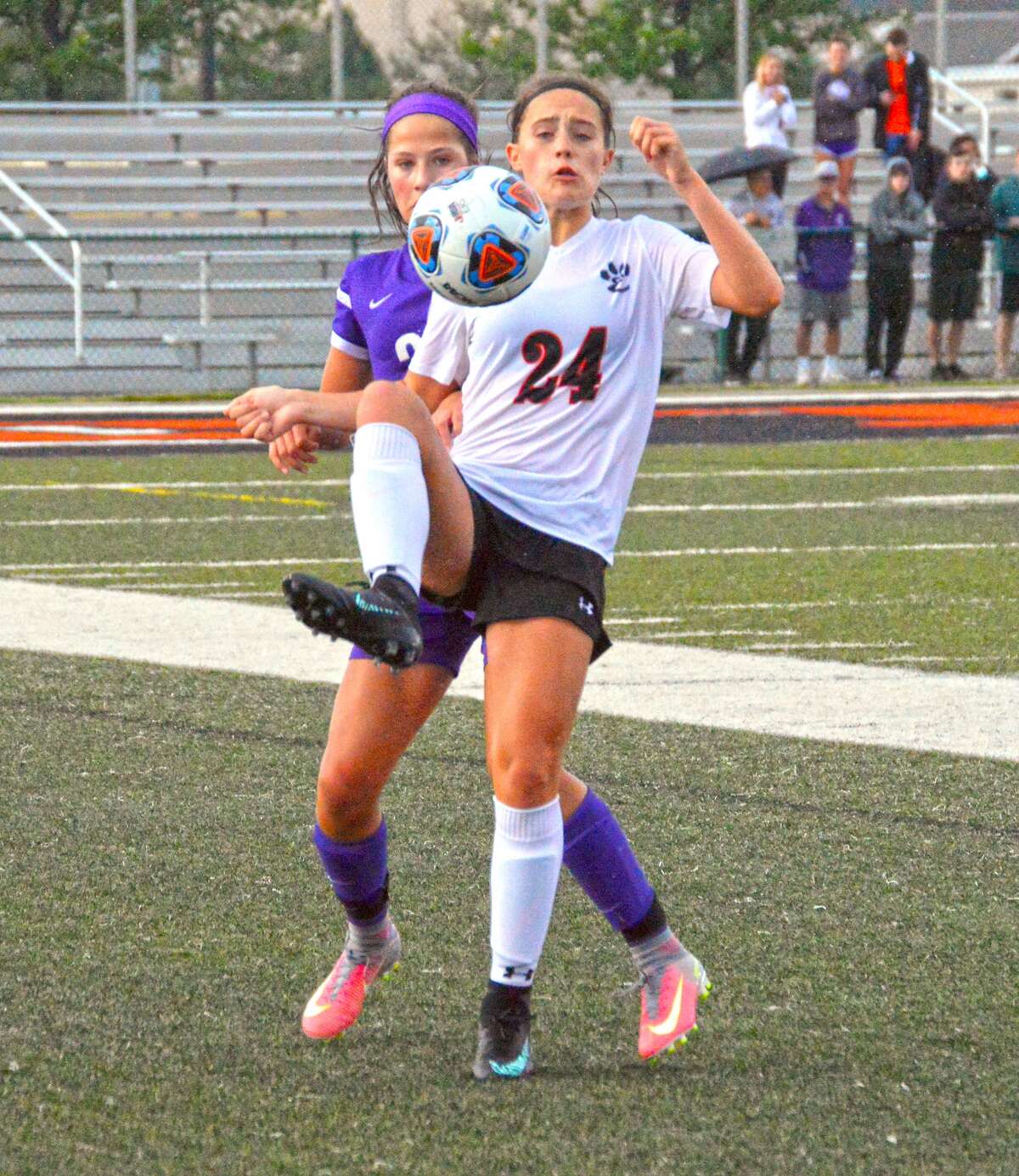 Edwardsville freshman forward Sydni Stevens, front, plays a ball from a throw-in midway through the first half of Tuesday’s game against Collinsville.