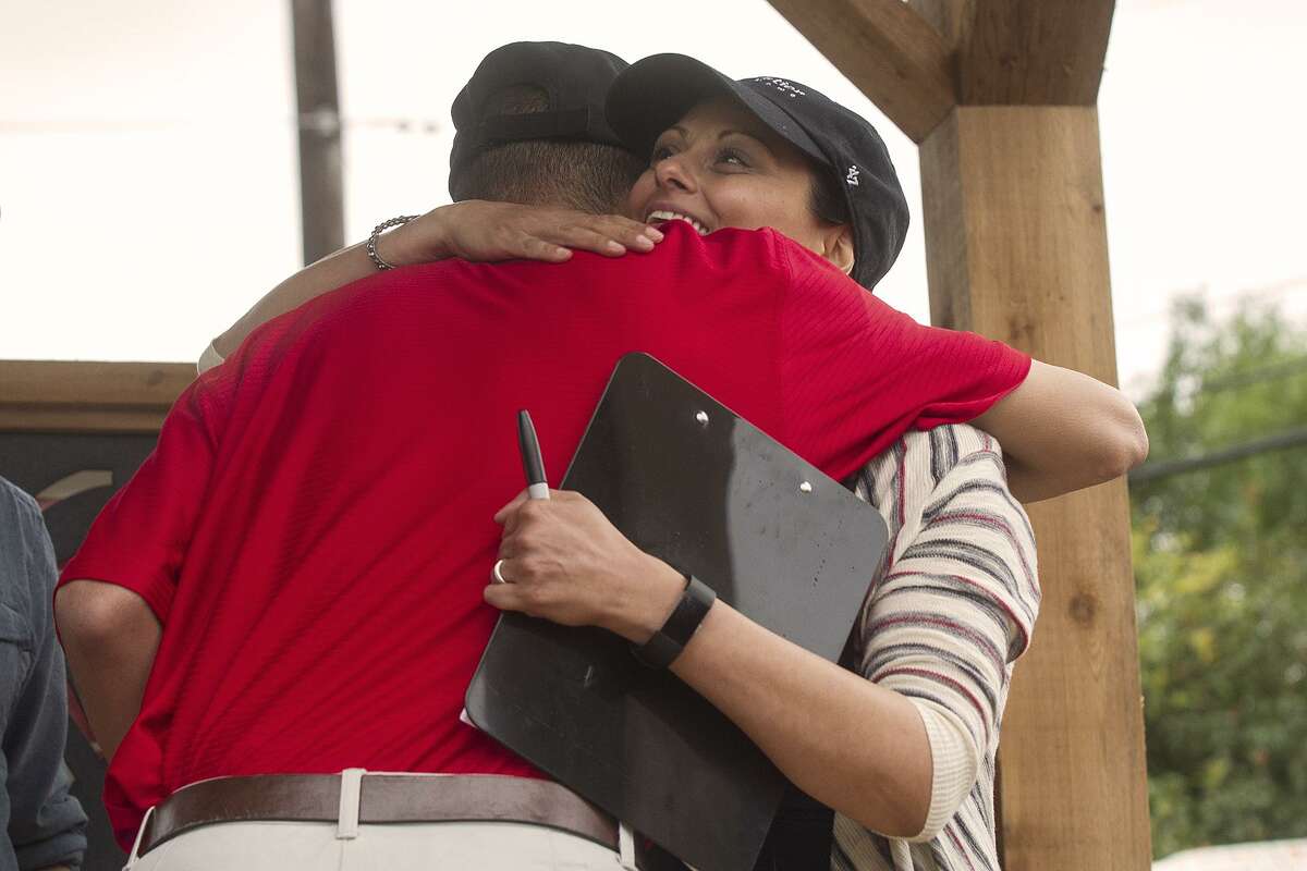 Freddy Rosario, hugs Gabrielle Rapport, co-founder and executive director of Operation Tiny Home after Operation Tiny Home presented Rosario with his new home, Saturday, May 20, 2017 at Warren High School.