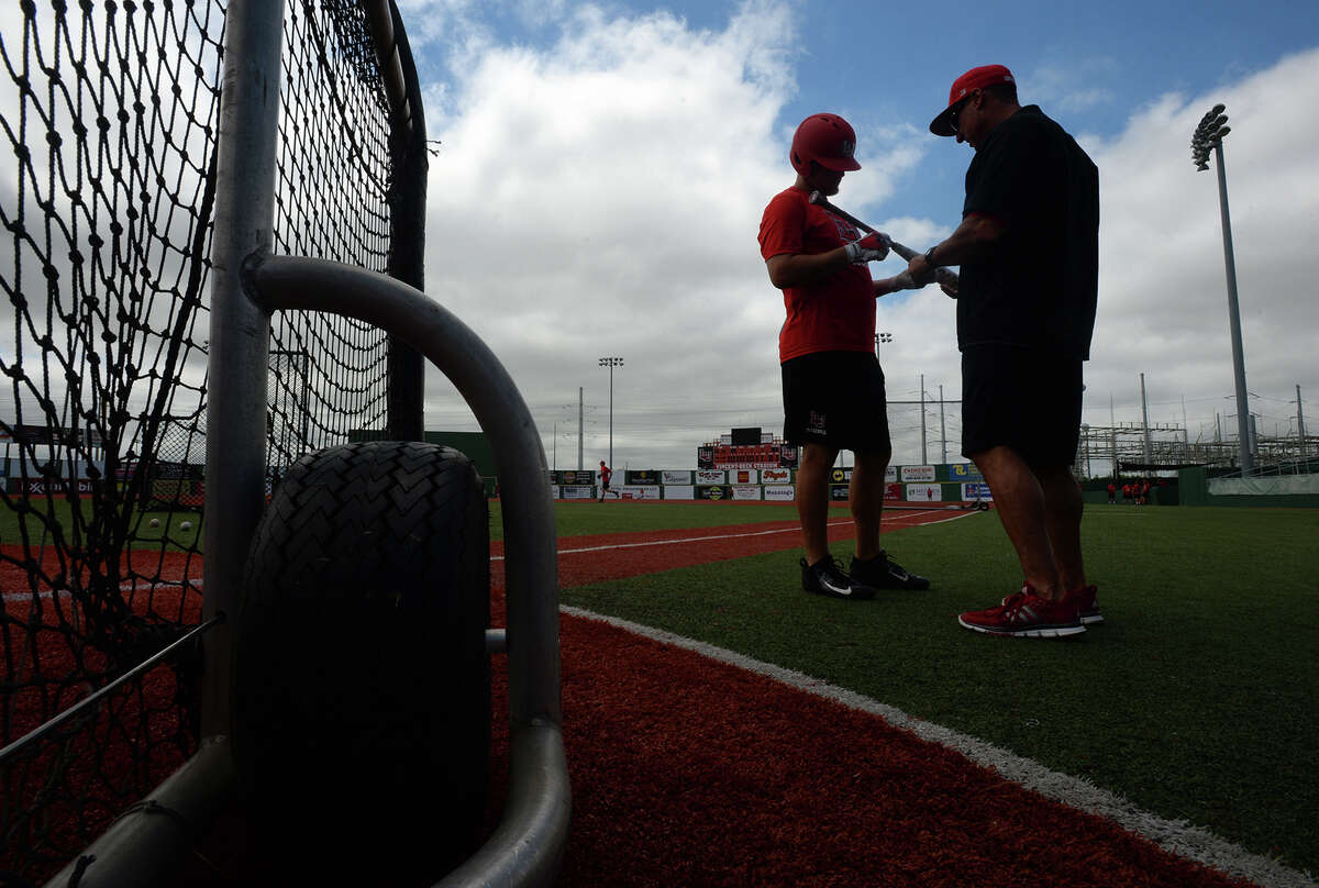 Lamar's Trey Silver, left, shows his bat to Scott Halten during practice on Tuesday. The Cardinals will play 8th seeded in this week's Southland Conference. Photo taken Tuesday, May 23, 2017 Guiseppe Barranco/The Enterprise