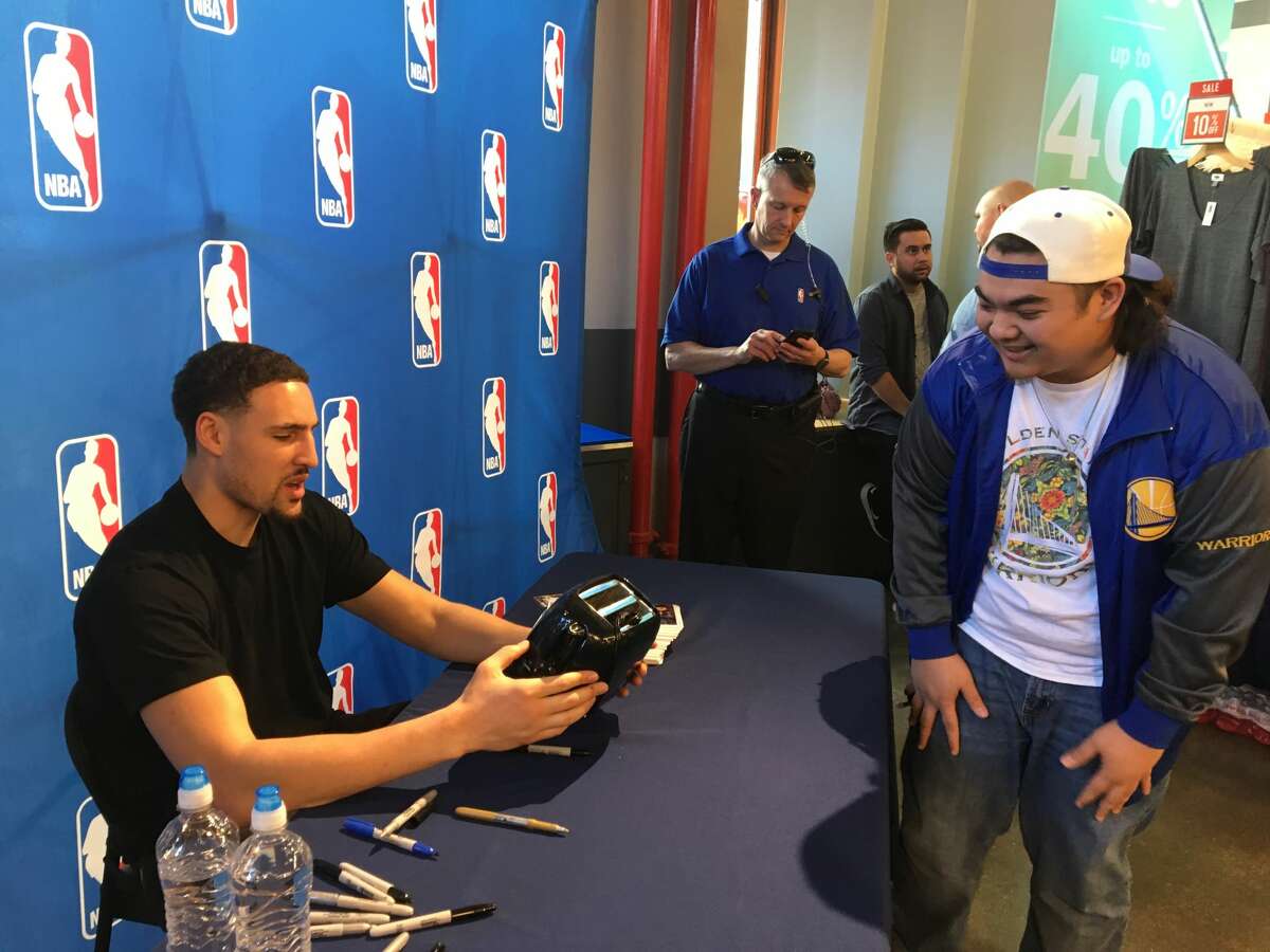 Ronnie Reyes gets his famous Warriors toaster signed by Klay Thompson.