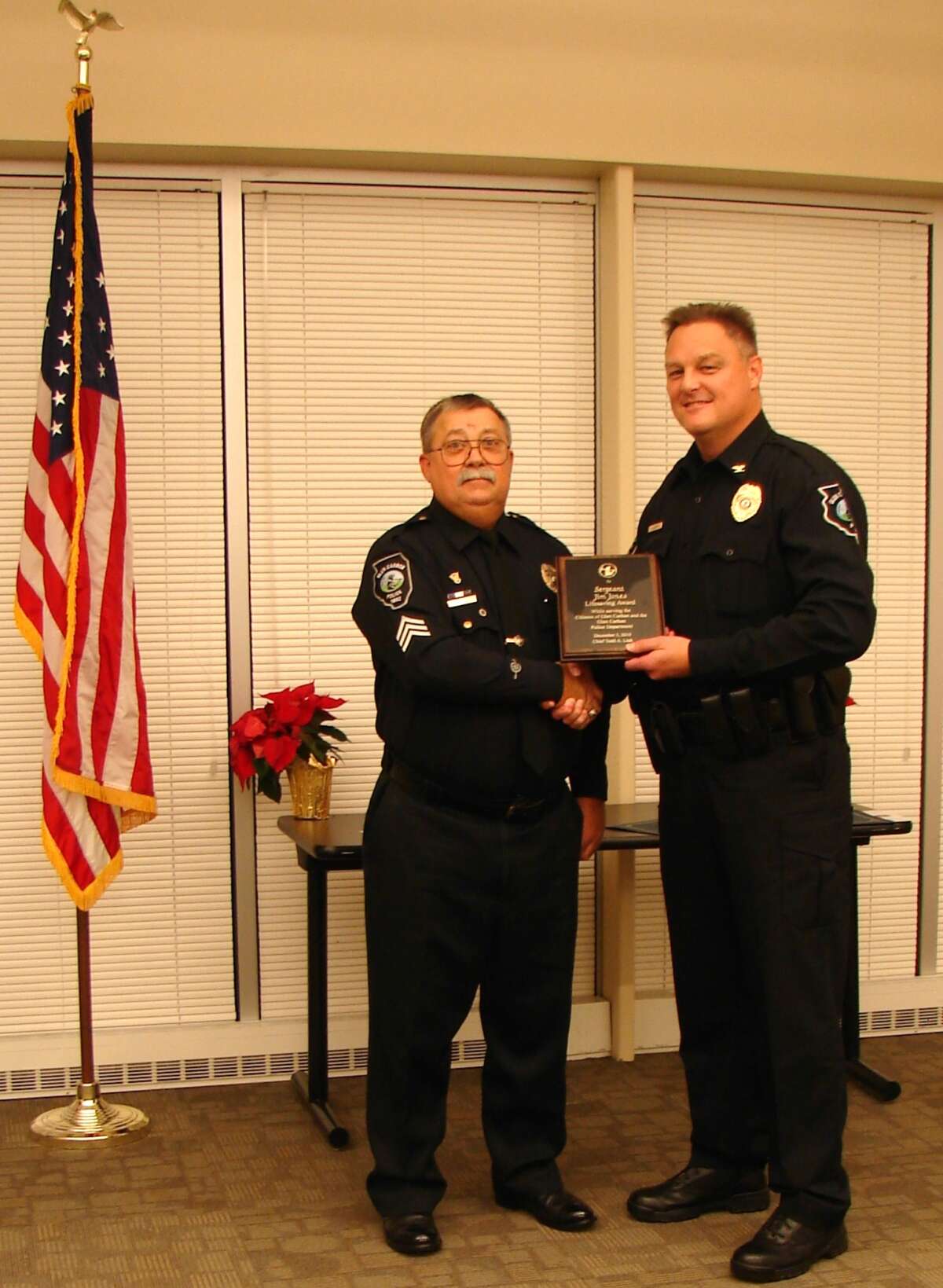 Sgt. James Jones is honored for his 40 years of service by Glen Carbon Police Chief, Todd Link. Jones is a familiar sight around town on his Police Motorcycle.