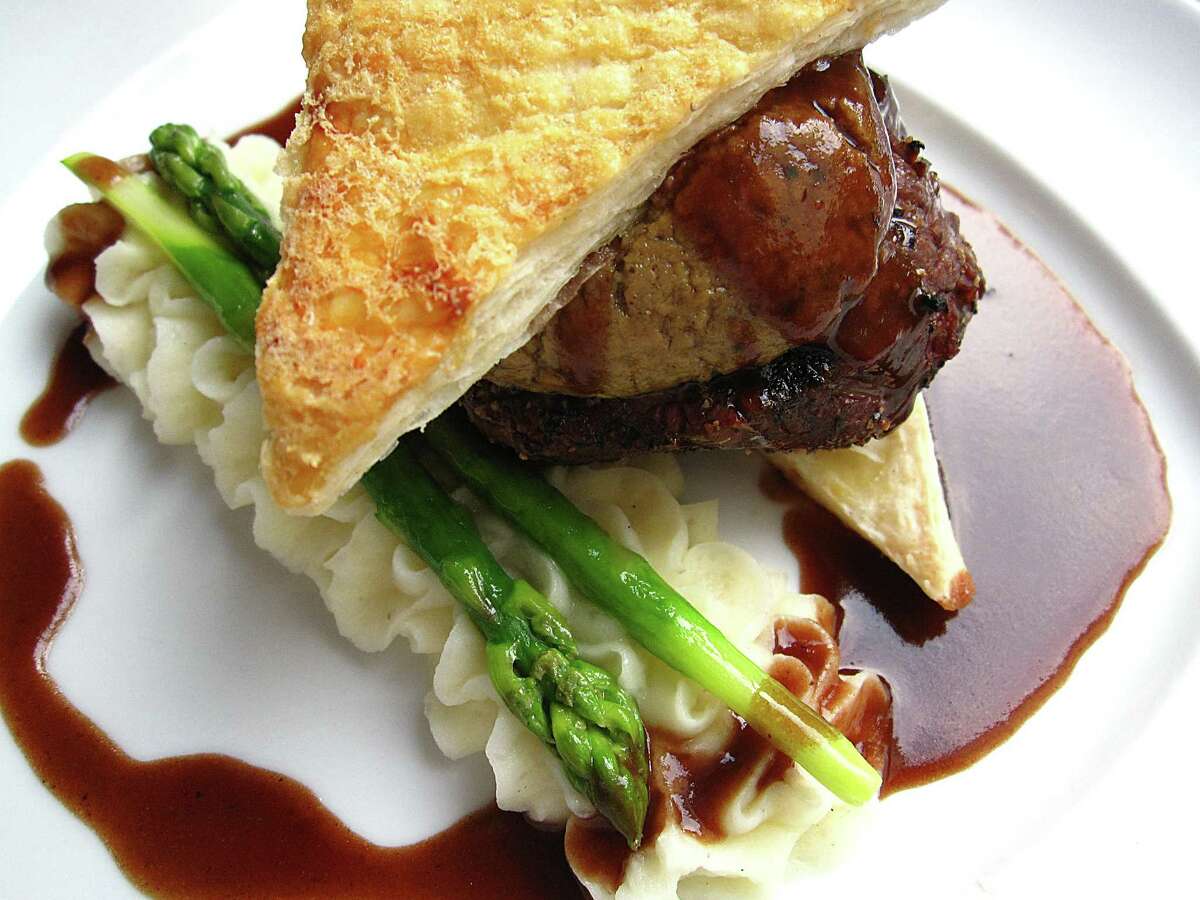 Beef Wellington with pastry and pâté, served with bordelaise sauce, potatoes mousseline and asparagus at Fig Tree Restaurant.