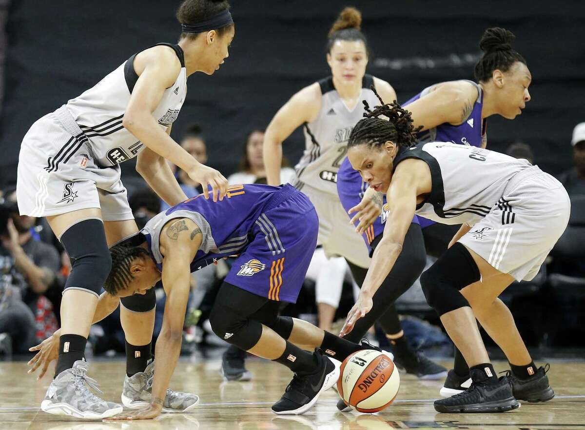 Stars’ Nia Coffey (from left) the Phoenix Mercury’s Yvonne Turner and the Stars’ Monique Currie try to corral a loose ball during first-half action on May 19, 2017, in San Antonio.