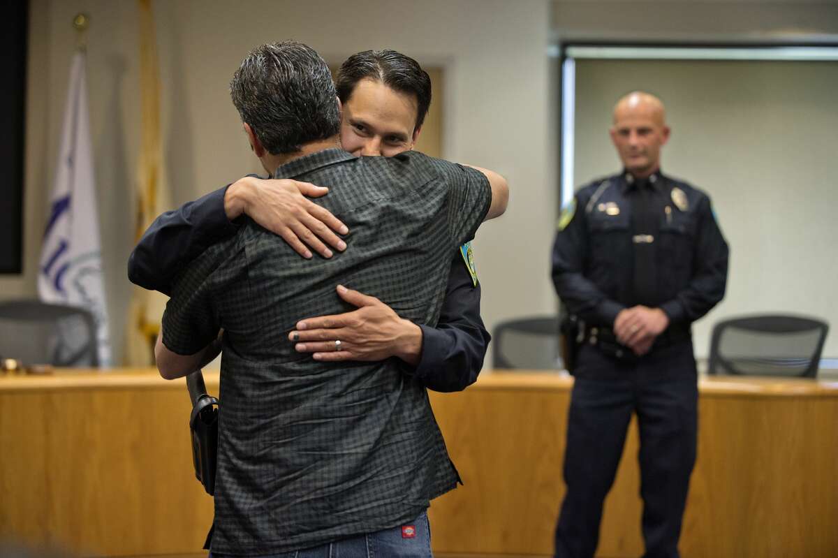 Newly sworn in Midland Police Officer Jose DeLeon gives his father Robert DeLeon a hug during an officer swearing-in ceremony at City Hall Wednesday afternoon. DeLeon, was joined by James Burchfield II and Christopher Hurst as new officers to the City of Midland Police Department.