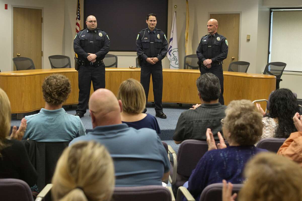 People gathered at City Hall applaud newly sworn-in Midland Police Officers Christopher Hurst, Jose DeLeon and James Burchfield II during an officer swearing-in ceremony Wednesday afternoon.