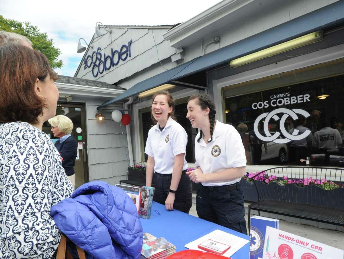 GEMS interns Amelia Hurst, 18, center, and Anna Heavey, 17, right, both Greenwich High School seniors during the GEMS fundraiser at Caren's Cos Cobber Restaurant in the Cos Cob section of Greenwich, Conn., Wednesday, May 24, 2017. Both interns were teaching CPR to patrons entering the restaurant. Caren Vizzo, the owner of the restaurant said 50% of the proceeds for the day go to GEMS from all the restaurant's sales. The Greenwich Emergency Medical Service, more commonly known as GEMS, is the sole provider of emergency services in the Town of Greenwich and is a non-profit organization.