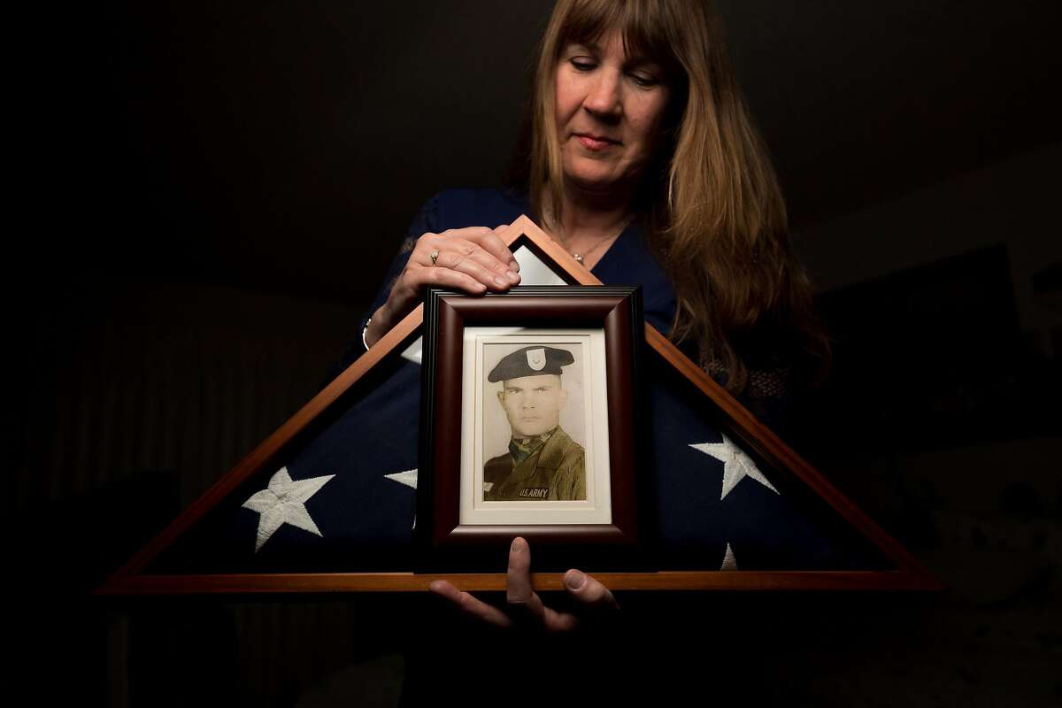 Kathy Strong displays a portrait of Army Spc. 5 James Moreland, a Green Beret who died during Vietnam’s Tet Offensive in February 1968. Strong, 57, has honored the memory of Moreland since she was 12.