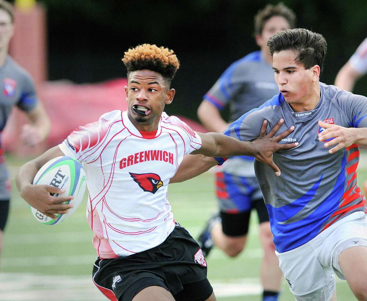Zhaire House of Greenwich with the ball stiff-arms a Fairfield Co-op defender during the state semi-final boys high school rugby match between Greenwich High School and Fairfield Co-Op at Greenwich High School, Greenwich, Conn., Wednesday May 24, 2017.