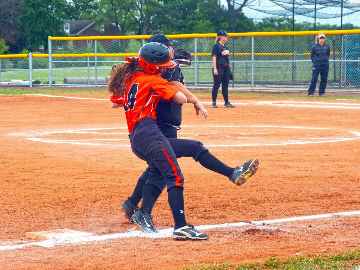 Edwardsville’s Lauren Taplin, left, runs into the Granite City third baseman during the first inning of Wednesday’s Class 4A O’Fallon Regional semifinal game.