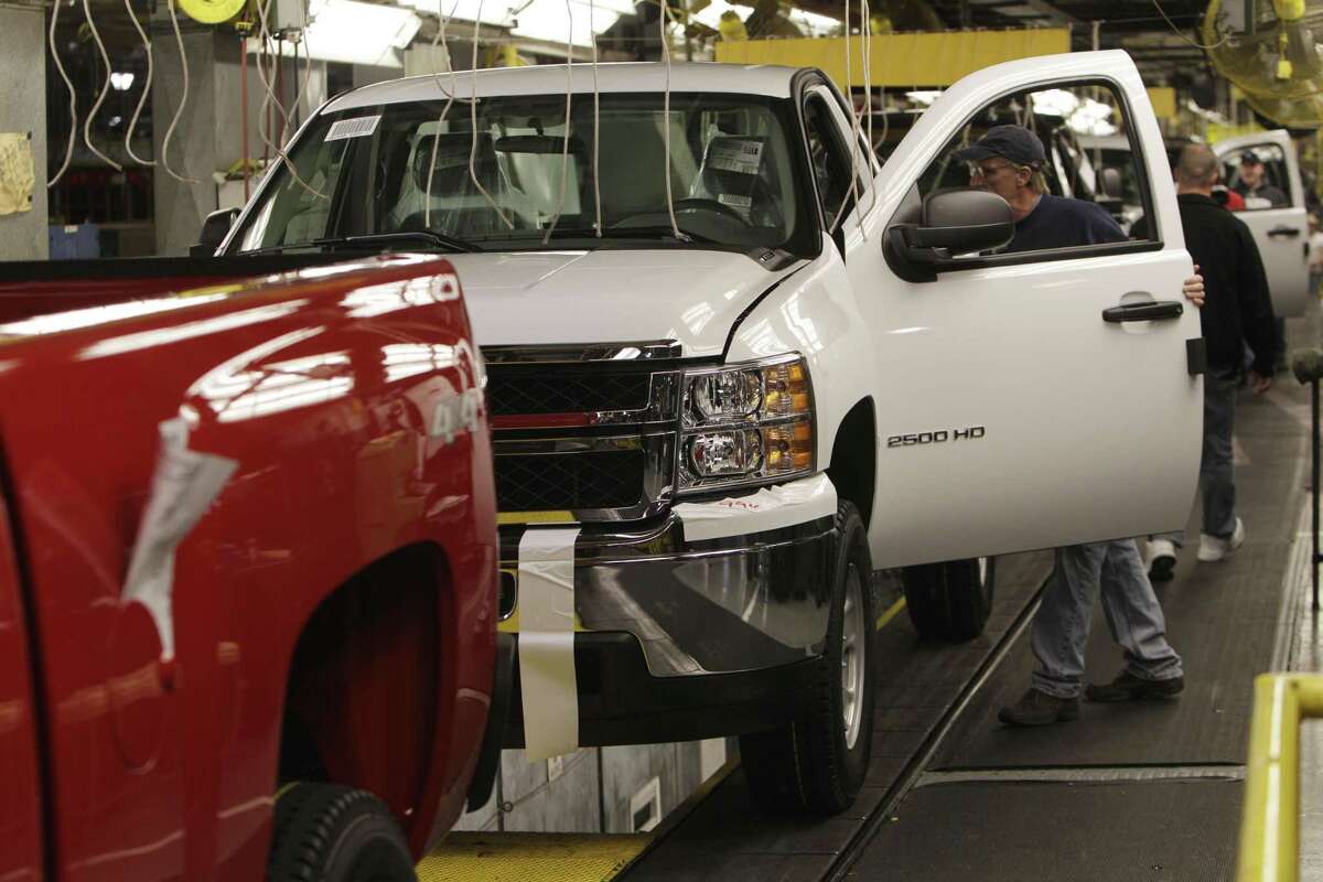General Motors Silverado and GMC Sierra pickup trucks on the assembly line in Michigan, in February 2011. (AP Photo/Carlos Osorio, file)