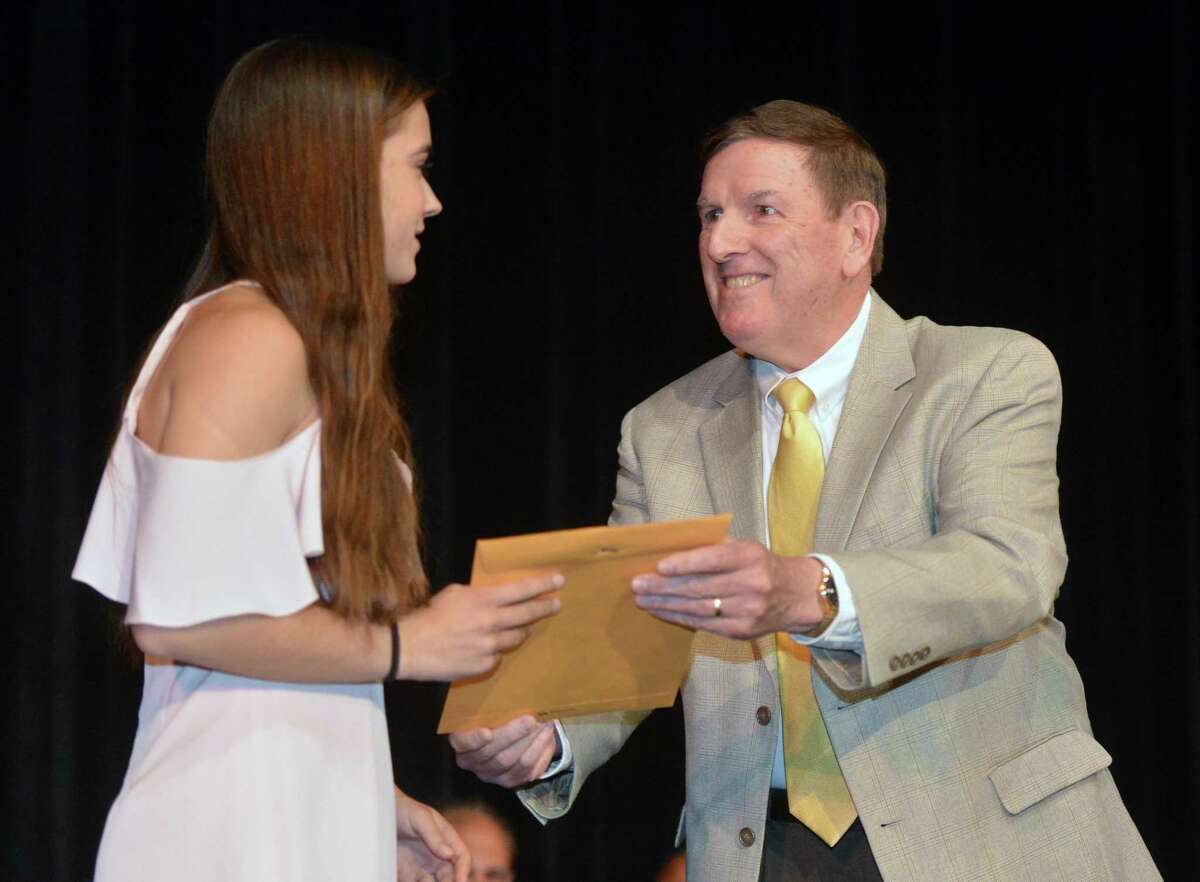 Chris Eidt presents Gracie Bradley with the Kevin M. Eidt Memorial Scholarship on Wednesday, May 24, 2017 during Norwalk High School Awards Night. The scholarship is for a student with outstanding achievement across the spectrum of academics, athletics, arts, and community and religious service.