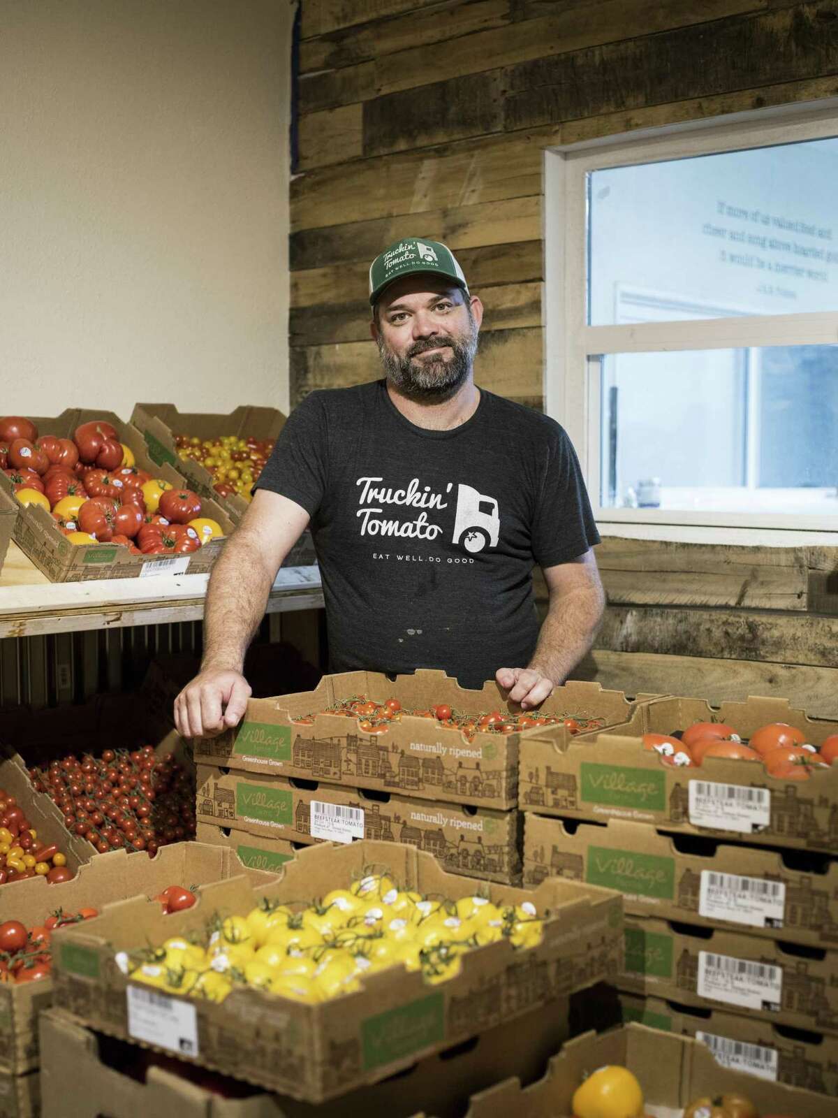 Bryan Pape of Trukin' Tomato poses for a portrait along with his produce for sale during the midweek market.