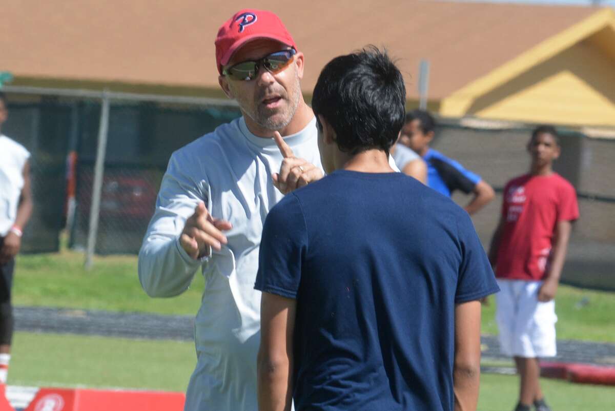 Plainview football defensive coordinator Lee Walker instructs a camper during a past Plainview Bulldog Football Camp of Champions. The football camp will kick off the summer schedule of PISD sports camps next week from Tuesday through Thursday. The Lady Bulldog volleyball camp will be next week from from Wednesday through Friday.