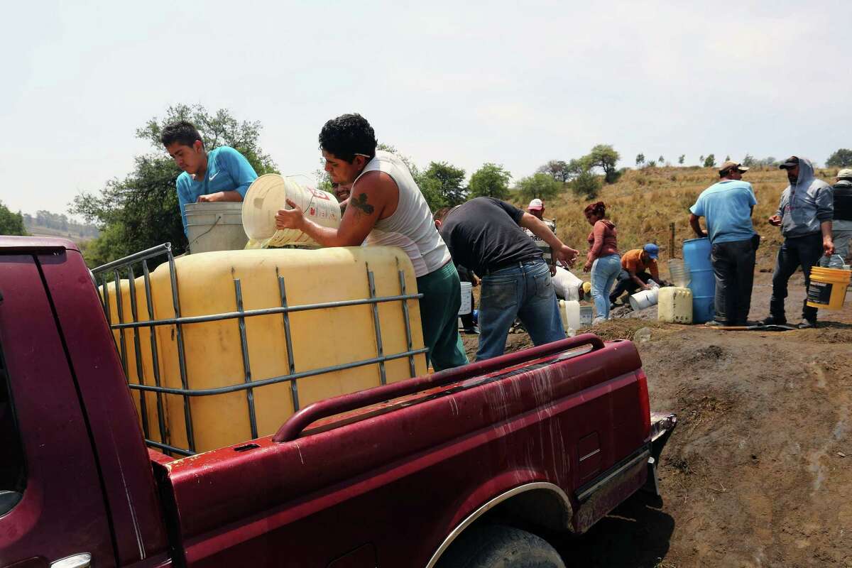 Mexican residents collect diesel from a leaking pipe in the southern state of Puebla. Mexico has faced chronic shortages of fuel as its state-run oil company Pemex has struggled to refine enough oil for domestic consumption and the government has loosened controls on fuel prices. Mexico is seeking to liberalize its energy industry after nearly 80 years of state control.
