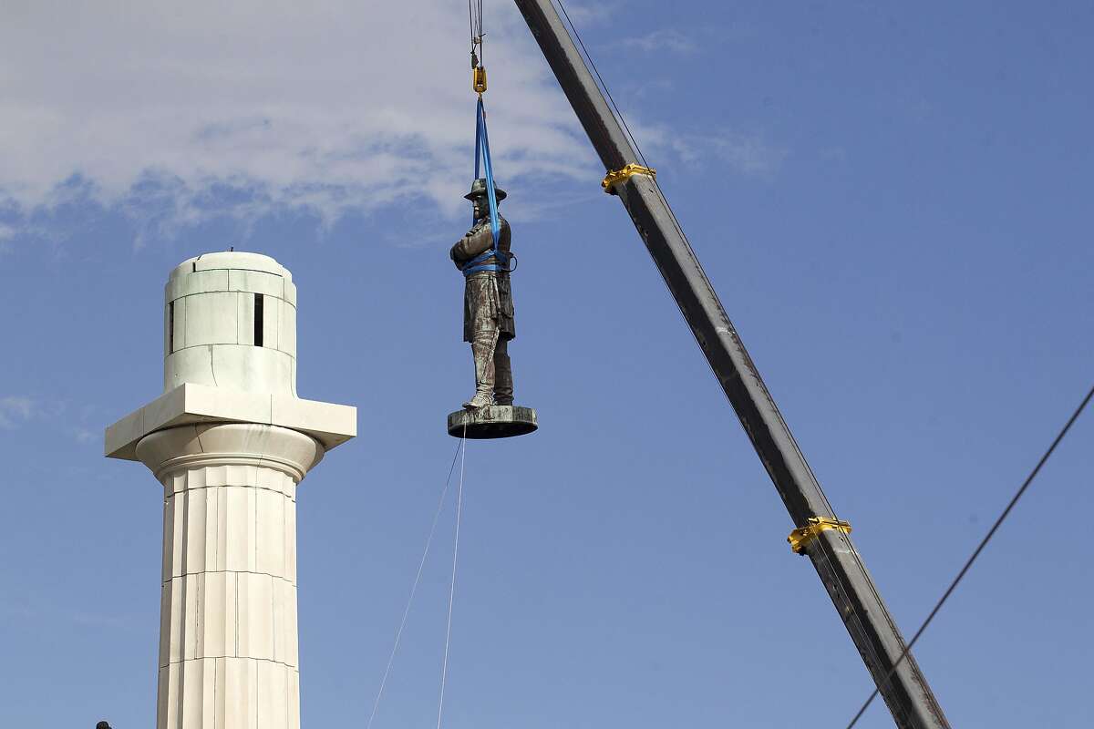 A statue of Confederate General Robert E. Lee is removed Friday, May 19, 2017, from Lee Circle in New Orleans. The city council voted to remove the monument and three other Confederate and white supremacist monuments in Dec. 2015. An obelisk honoring the militia known as the White League was taken down in April; a statue of Confederate President Jefferson Davis was removed May 11; and a statue of Confederate General P.G.T. Beauregard was taken down on Wednesday. (AP Photo/Scott Threlkeld)