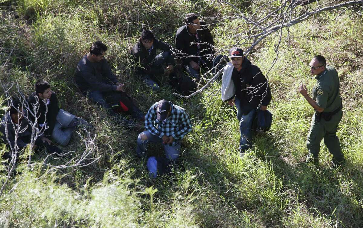 With the support of a U.S. Customs and Border Protection Air and Marine Operations Bell Huey, Border Patrol agents capture a group illegal immigrant hiding in brush on a ranch northeast of Rio Grande City, Texas, Tuesday, Oct. 4, 2016.