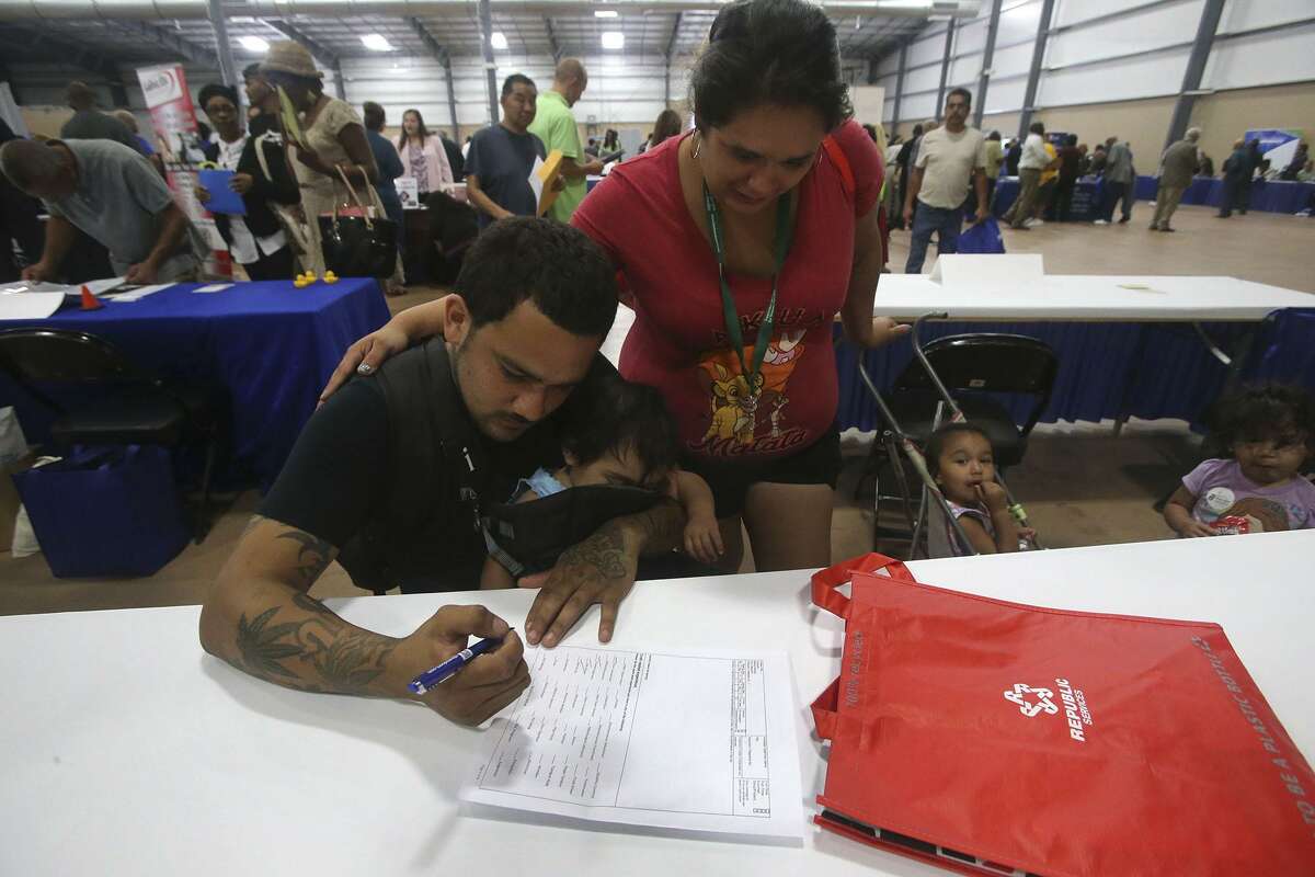Christopher Hernandez fills out a job application with Ylora (cq) Posada Thursday May 25, 2017 during the Bexar County Second Chance Job Fair held at the Freeman Expo Hall. There were opportunities available in a variety of industries including hospitality, food service, construction, electrical, flooring, information, transportation, warehousing, assembly, automotive, telemarketing, and trucking. The fair featured businesses that are committed to hiring formally incarcerated local residents from all education and skill levels.
