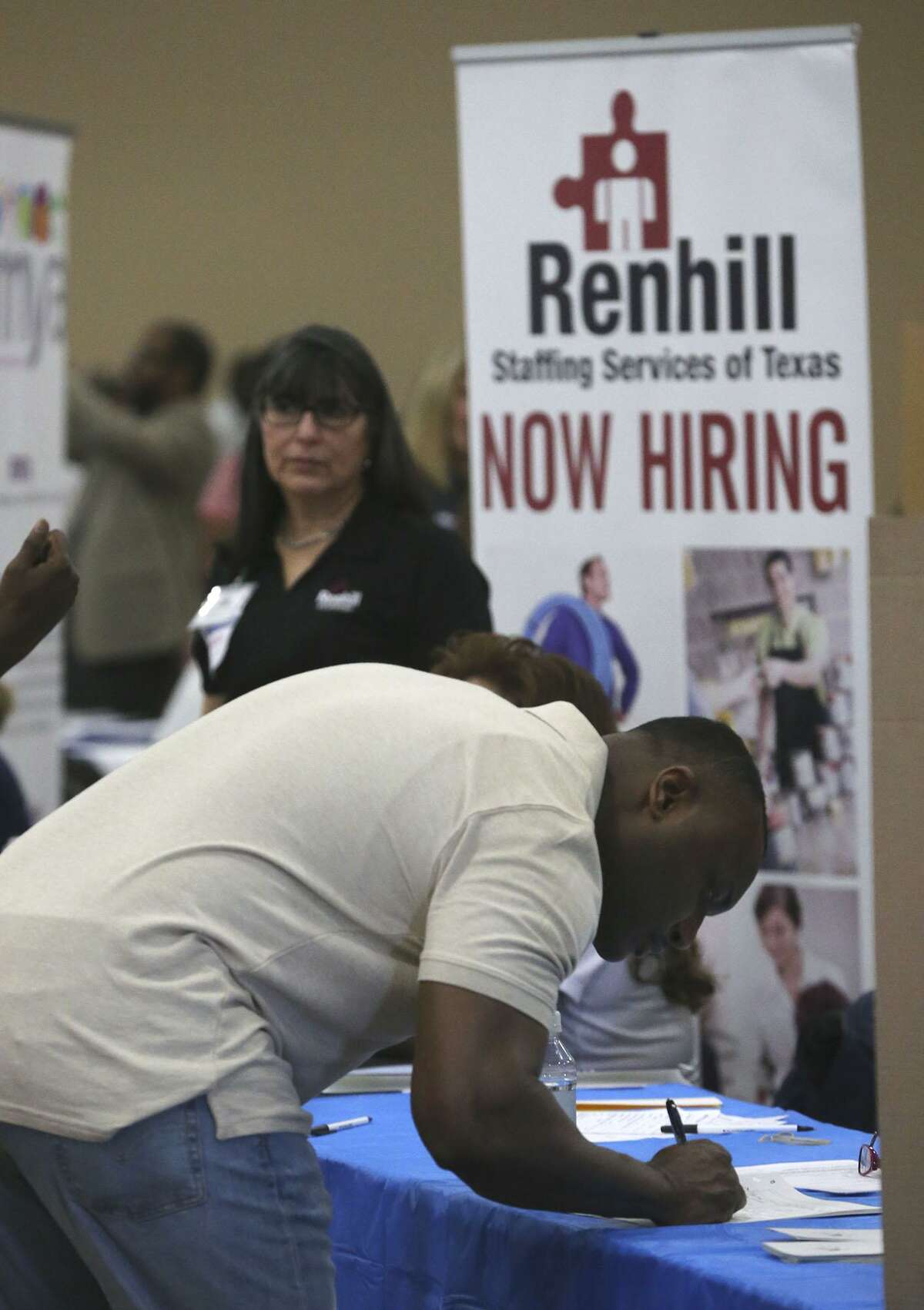 A job seeker fills out paper work during the Bexar County Second Chance Job Fair held at the Freeman Expo Hall. There were opportunities available in a variety of industries including hospitality, food service, construction, electrical, flooring, information, transportation, warehousing, assembly, automotive, telemarketing, and trucking.