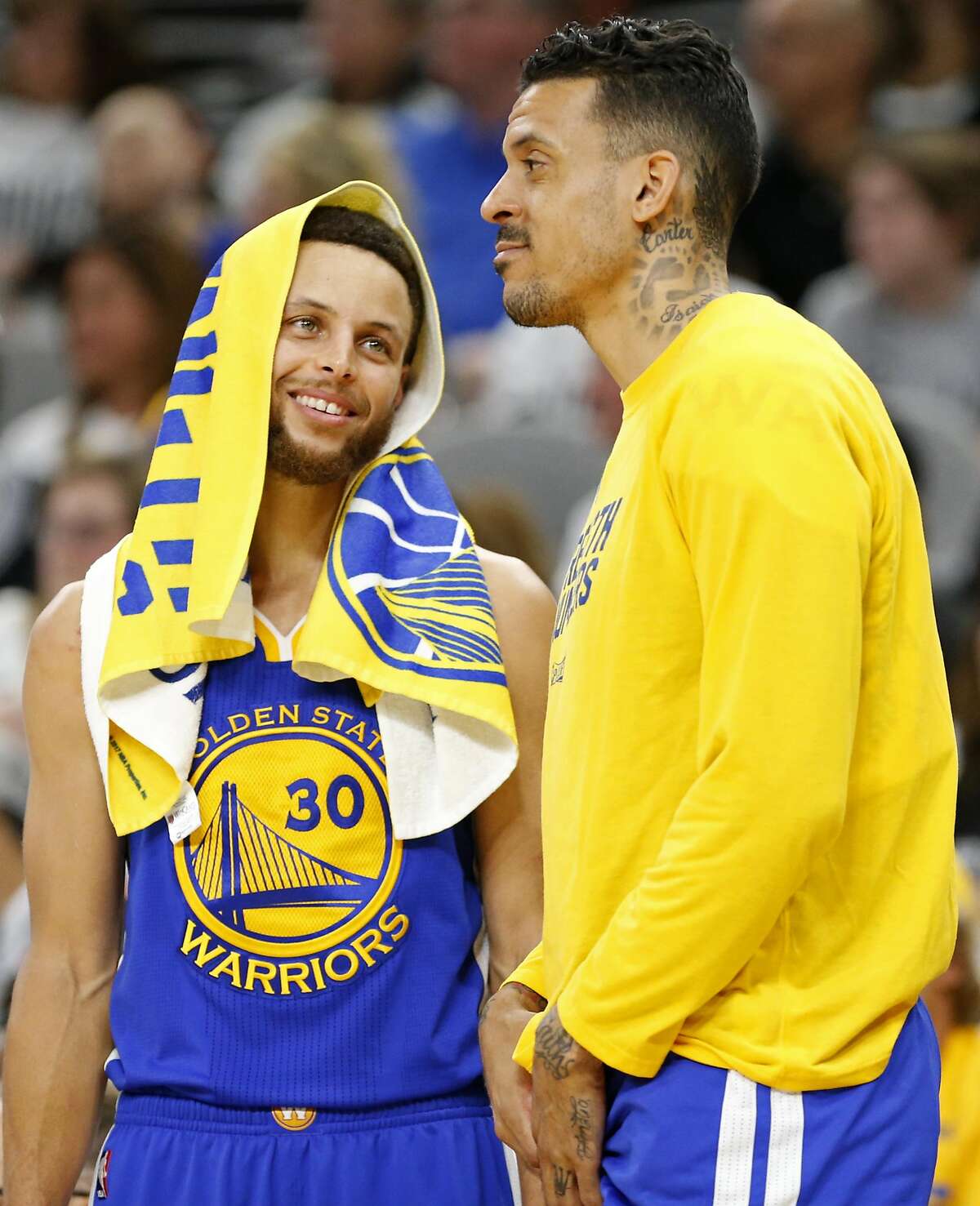FILE - Golden State Warriors' Stephen Curry (left) talks with Matt Barnes on the bench during second half action in Game 3 of the Western Conference Finals against the San Antonio Spurs held Saturday May 20, 2017 at the AT&T Center.