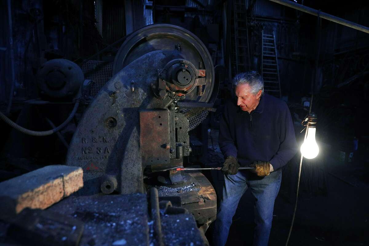 Tony Rosellini works on a manhole cover hook at Edwin Klockar's Blacksmithing Shop in San Francisco, Calif., on Wednesday, May 24, 2017. The shop is a piece of the last working bit of old Rincon Hill, a blacksmith shop on Folsom Street. It's a city landmark, with dirt floors in the back. But Tony Rosellini, the blacksmith is 87 years old, and its fate is in the air. Travis Kelly, his grandson, is rethinking the place.
