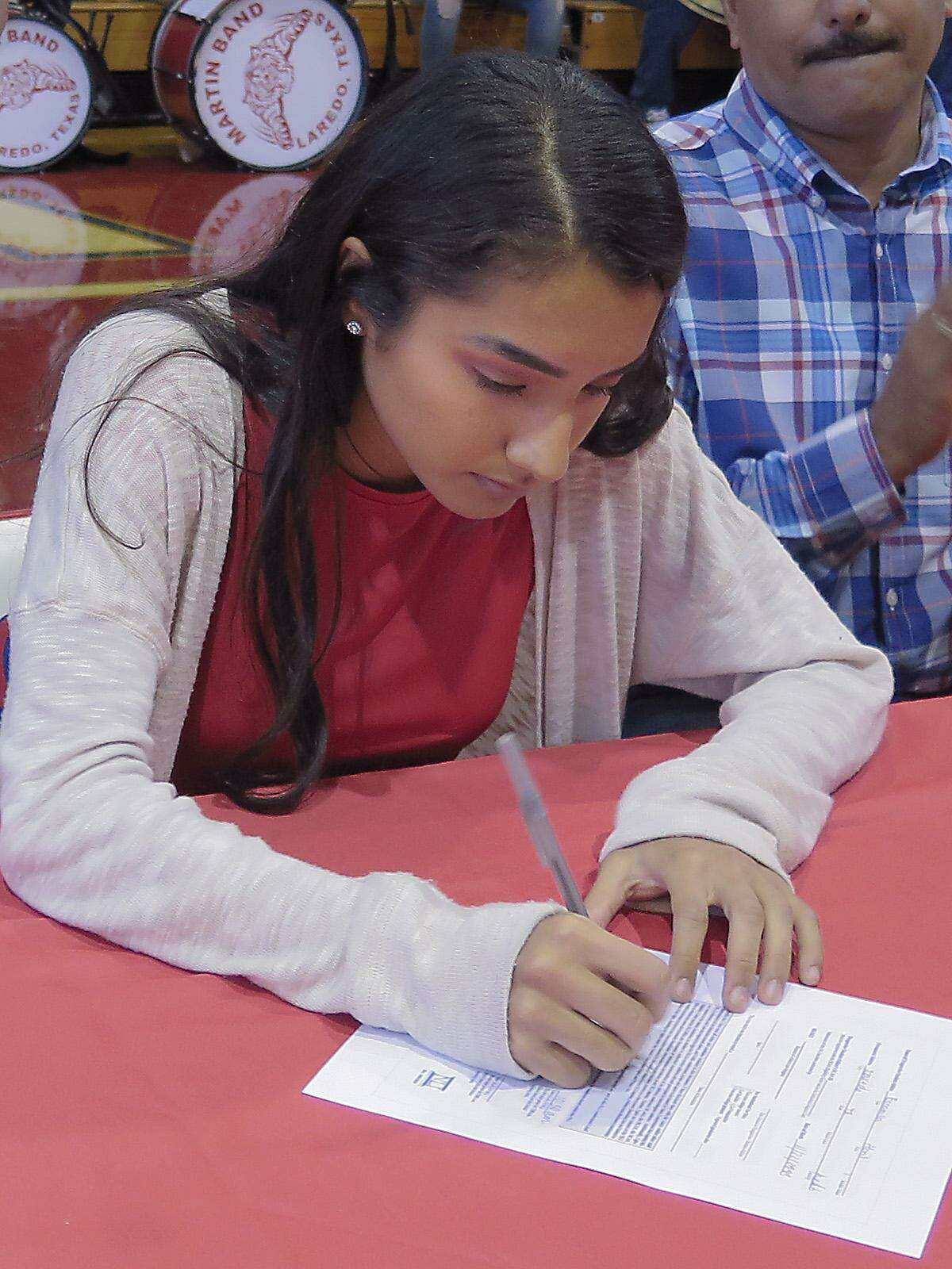 Martin High School athlete Abril Escamilla signs her letter of intent to run for A& Corpus Christi.