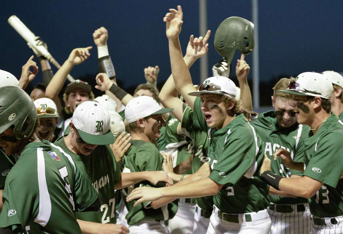 Reagan players celebrate a run during Game 1 of their Region IV-6A semifinal playoff baseball series against Southwest on May 25, 2017, at SAISD Sports Complex in San Antonio.