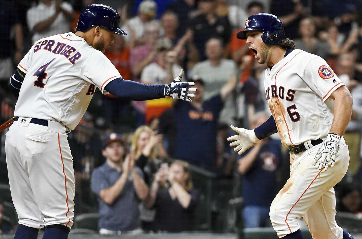 Houston Astros' Jake Marisnick (6) celebrates his go-ahead solo home run off relief pitcher Alex Wilson (30) with George Springer during the eighth inning of a baseball game, Thursday, May 25, 2017, in Houston. (AP Photo/Eric Christian Smith)