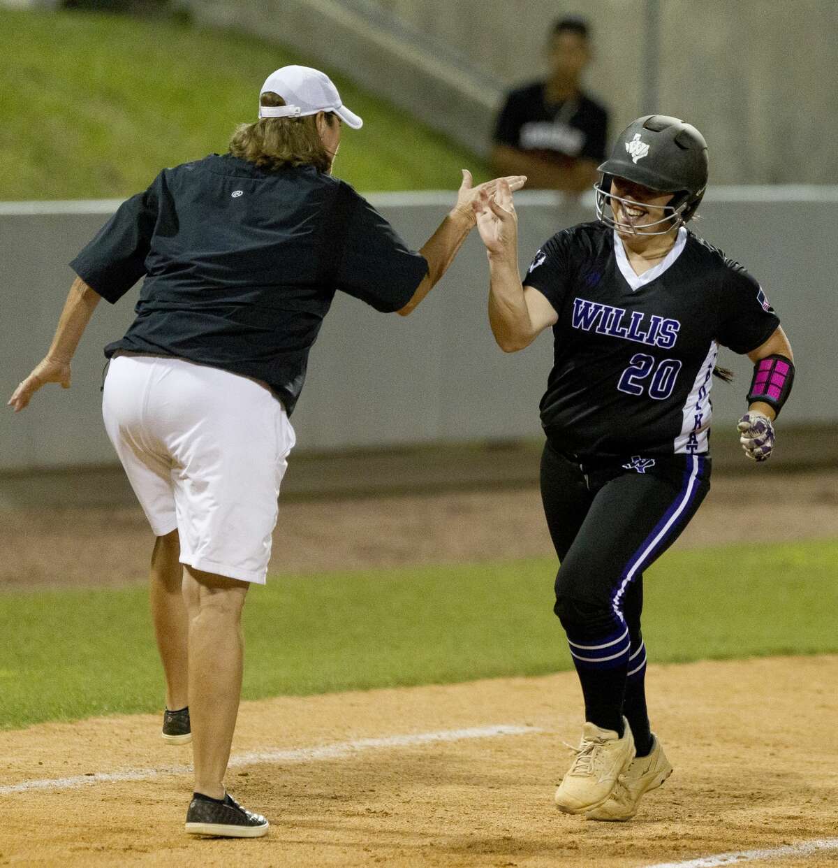 Willis head coach Stephanie Shelly gives Suzy Lopez a high-five after hitting a grand-slam off Barbers Hill starting pitcher Meagan King during the first inning in Game 1 of a Region III-5A final high school softball series at Cougar Softball Stadium, Thursday, May 25, 2017, in Houston.
