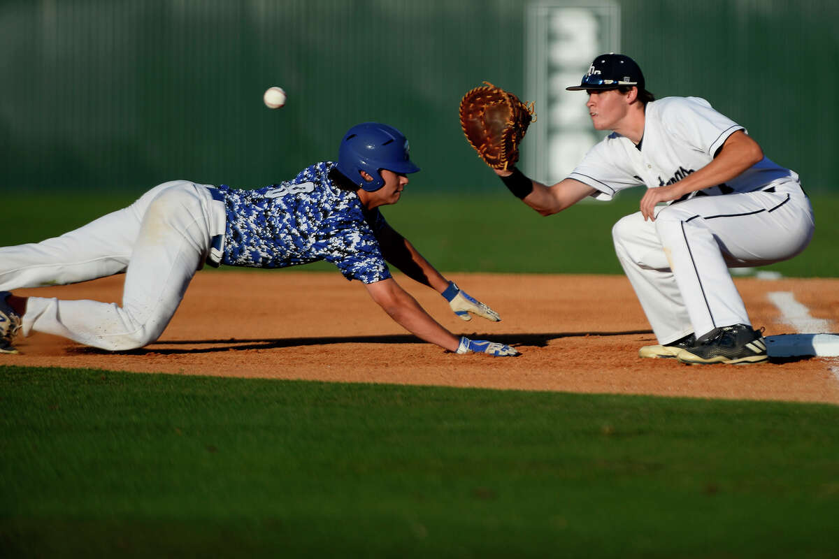 Robinson's Mason Cooper dives back to first base as West Orange-Stark's Kaleb Ramsey attempts to make the tag in a Class 4A regional semifinal baseball game at Magnolia High School on Thursday night. Photo taken Thursday 5/25/17 Ryan Pelham/The Enterprise