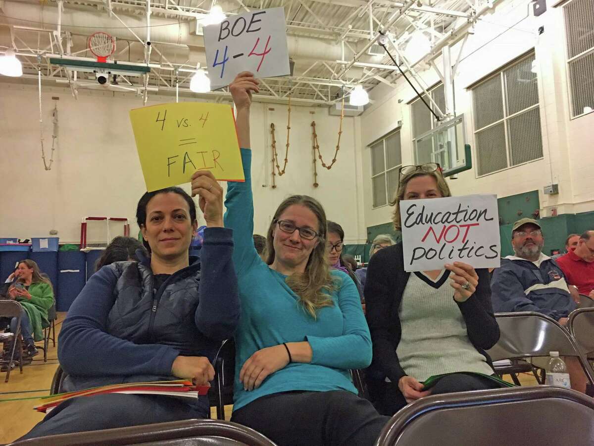 Nerlyn Pierson, Lindsey Fahey and Joanna Swomley, Greenwich residents and members of Indivisible Greenwich, a liberal activism group, brought signs to the Board of Education meeting Thursday, indicating their opinion on the proposec change to the Board of Education's election structure.