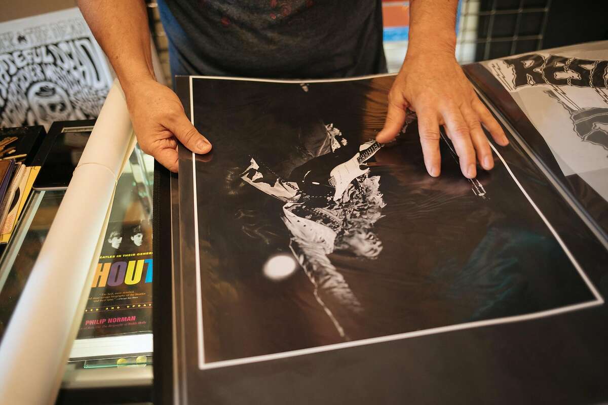Larry Chavez, owner of Rock and Roll Experience, shows off a rare Jimi Hendrix photo at his store in Monterey, Calif. Thursday, May 11, 2017.