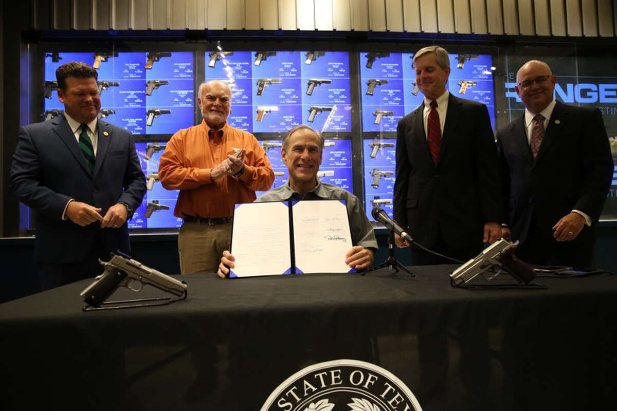 Texas Gov. Greg Abbott signs into law SB 16, which lowers the first-time fee for a license to carry a firearm to $40, a cut of $100. Additionally, the renewal fee has been lowered from $70 to $40. Pictured with Abbott are Senator Robert Nichols (R-Jacksonville), who represents Liberty and San Jacinto counties in Senate District 3. In addition to Nichols, the bill was authored by Senator Joan Huffman (R-Houston) and State Rep. Phil King (R-Weatherford).