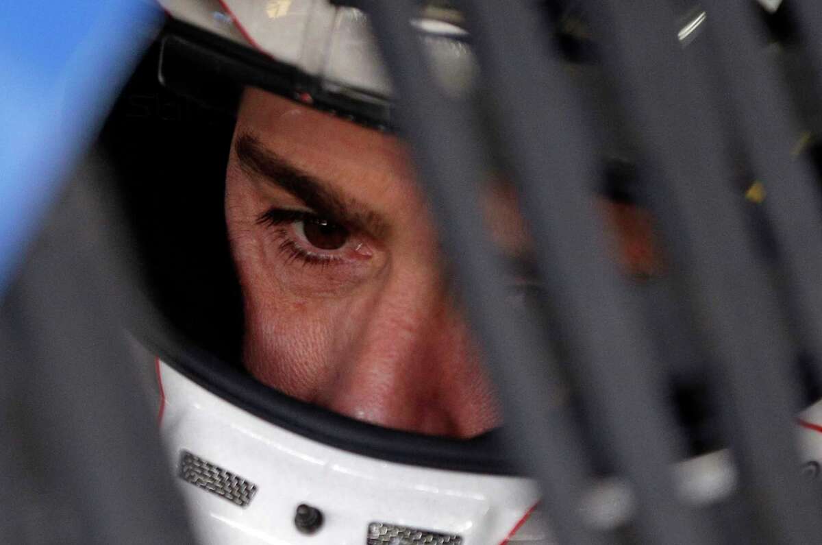 Jimmie Johnson looks from his car before practice for Sunday's NASCAR Cup series auto race at Charlotte Motor Speedway in Concord, N.C., Thursday, May 25, 2017. (AP Photo/Chuck Burton)
