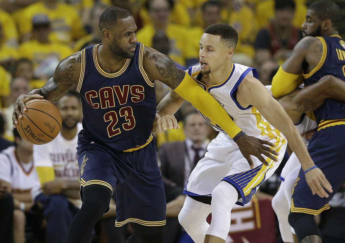 Cleveland Cavaliers forward LeBron James dribbles against Golden State Warriors guard Stephen Curry during the 2016 NBA finals.