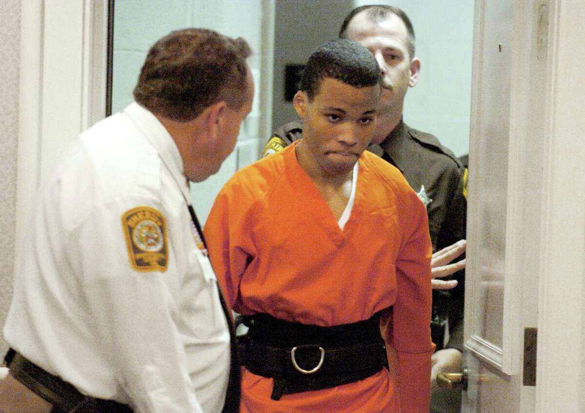 FILE - In this Oct. 26, 2004, file photo, Lee Boyd Malvo enters a courtroom in the Spotsylvania, Va., Circuit Court. A federal judge has tossed out two life sentences for D.C. sniper shooter Lee Boyd Malvo and ordered Virginia courts to hold new sentencing hearings. In a ruling issued Friday, U.S. District Judge Raymond Jackson in Norfolk said Malvo is entitled to new sentencing hearings after the U.S. Supreme Court ruled that mandatory life sentences for juveniles are unconstitutional. (Mike Morones/The Free Lance-Star via AP)