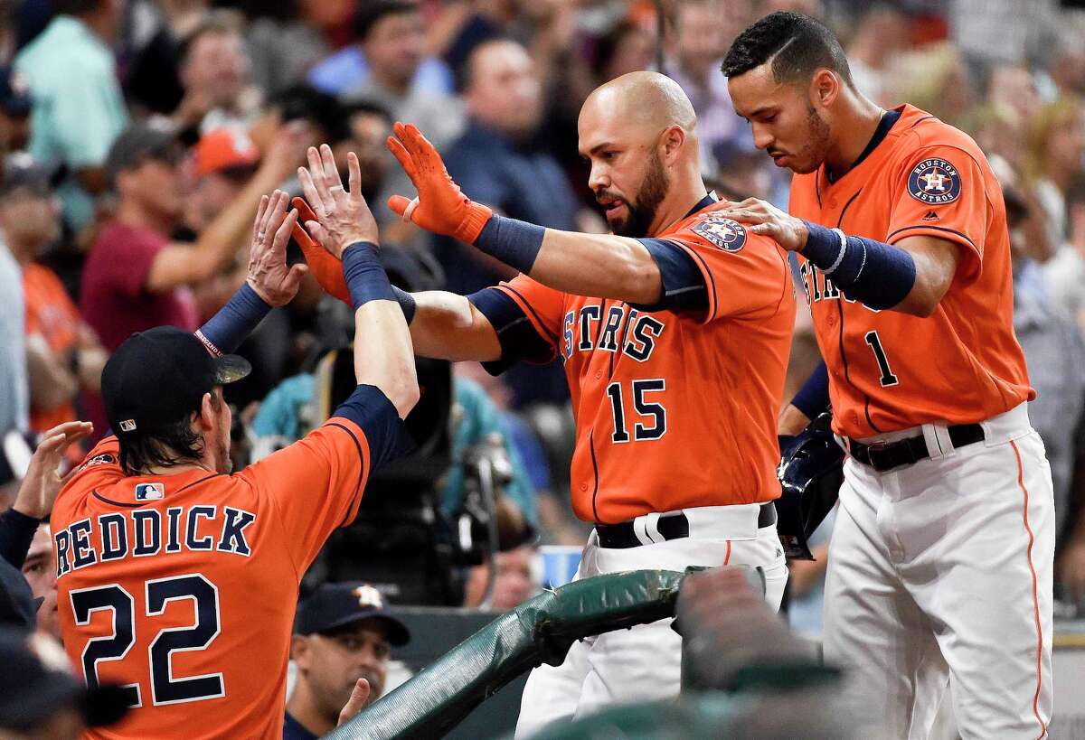 Houston Astros' Carlos Beltran (15) celebrates his solo home run off Baltimore Orioles starting pitcher Kevin Gausman with teammates Carlos Correa, right, and Josh Reddick (22) during the sixth inning of a baseball game, Friday, May 26, 2017, in Houston. (AP Photo/Eric Christian Smith)