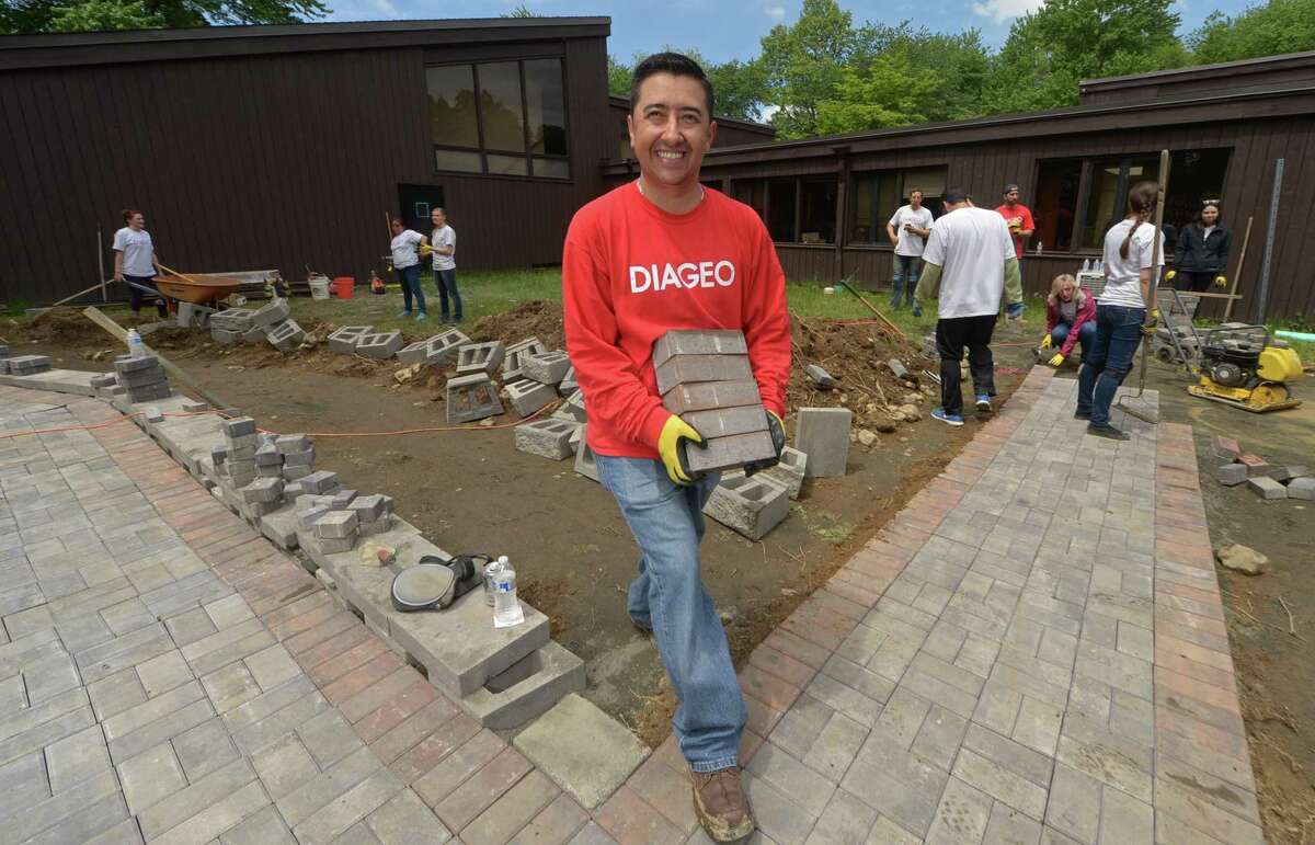 More than 110 employees from Diageo North America’s finance team including Juan Vallejo return to STAR on Wednesday, May 24, to complete phase two of a transformational service project at the STAR, Inc. Lighting the Way Center in Norwalk. The crew’s worked on extending a brick handicapped walkway, constructing a patio around the new STAR greenhouse, creating raised beds for a wheelchair-accessible herb, vegetable and flower garden, fencing it in and adding decorative mulch and specimen landscape plantings. STAR is a nonprofit organization that has provided services to individuals with developmental disabilities in mid-Fairfield County since 1952.