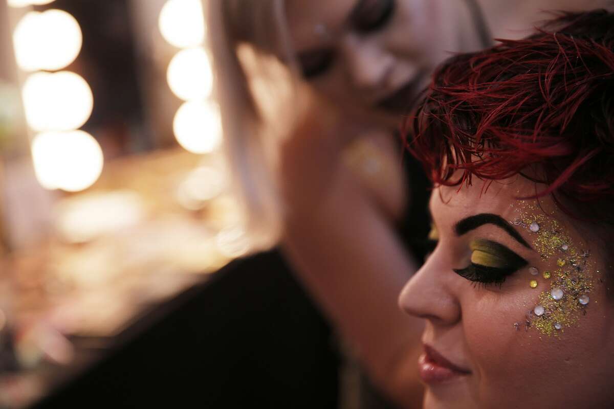Michelle Frank of Suisun gets her makeup done by cosmetologist Erika Myers during BottleRock on Saturday, May 27, 2017, in Napa, Calif.