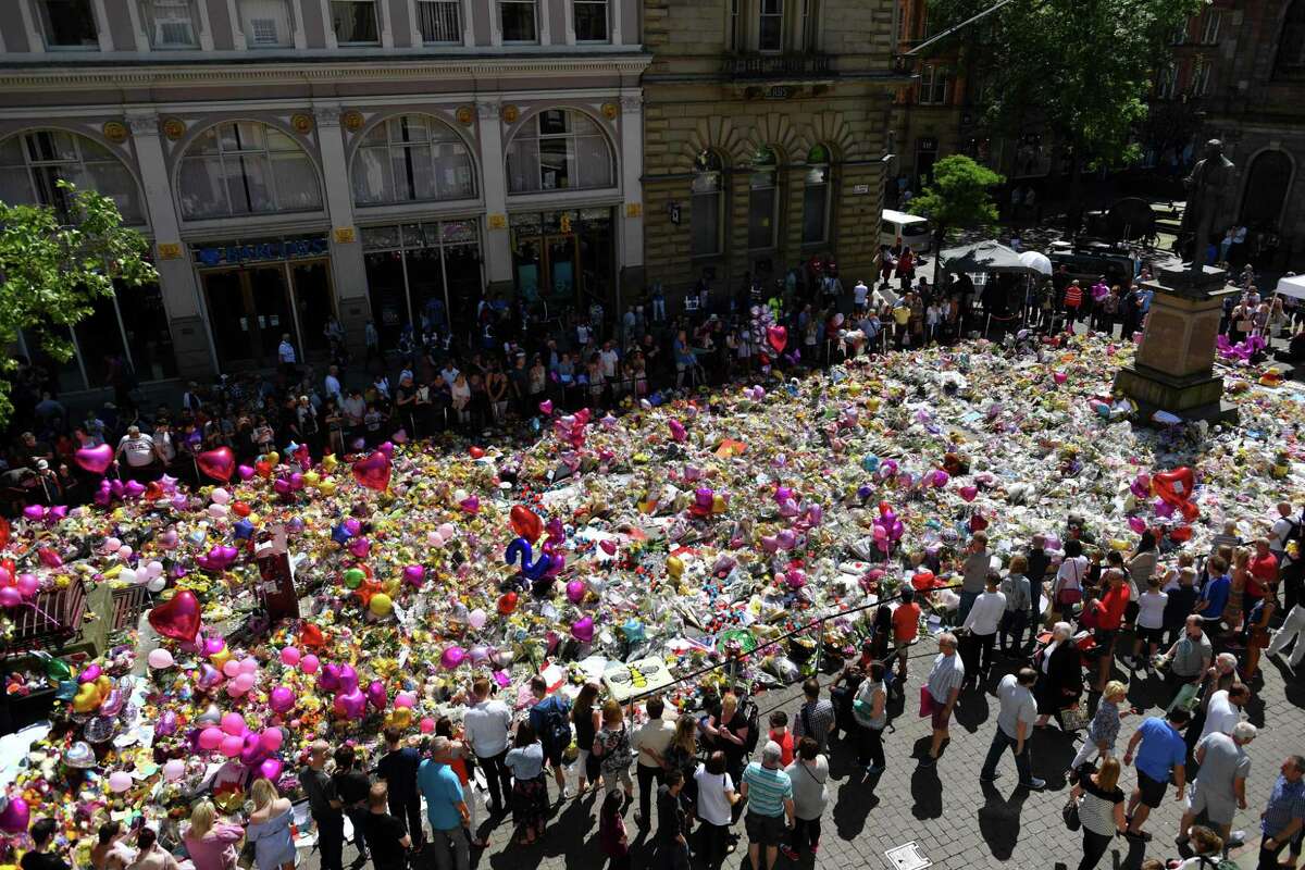 A carpet of floral tributes to the victims of the Manchester attack lies in St Ann's Square.