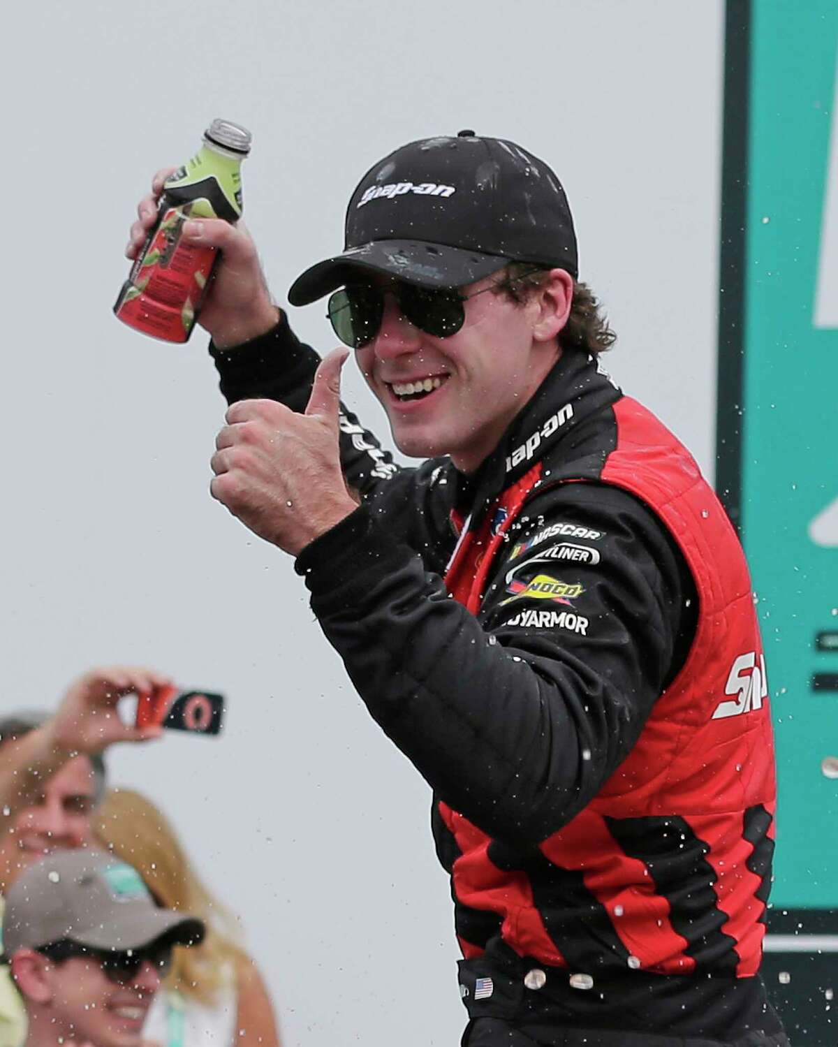 Ryan Blaney celebrates in Victory Lane after winning the NASCAR Xfinity series auto race at Charlotte Motor Speedway in Concord, N.C., Saturday, May 27, 2017. (AP Photo/Chuck Burton)