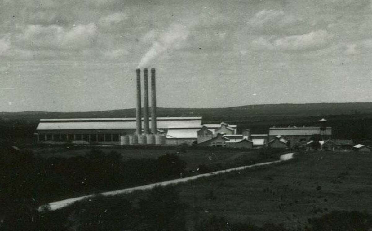 This archival photo shows the exterior of the San Antonio Portland Cement Company with its three smokestacks, which still tower over the Alamo Quarry market today. This photo was published Dec. 26, 1926, in the San Antonio Light.