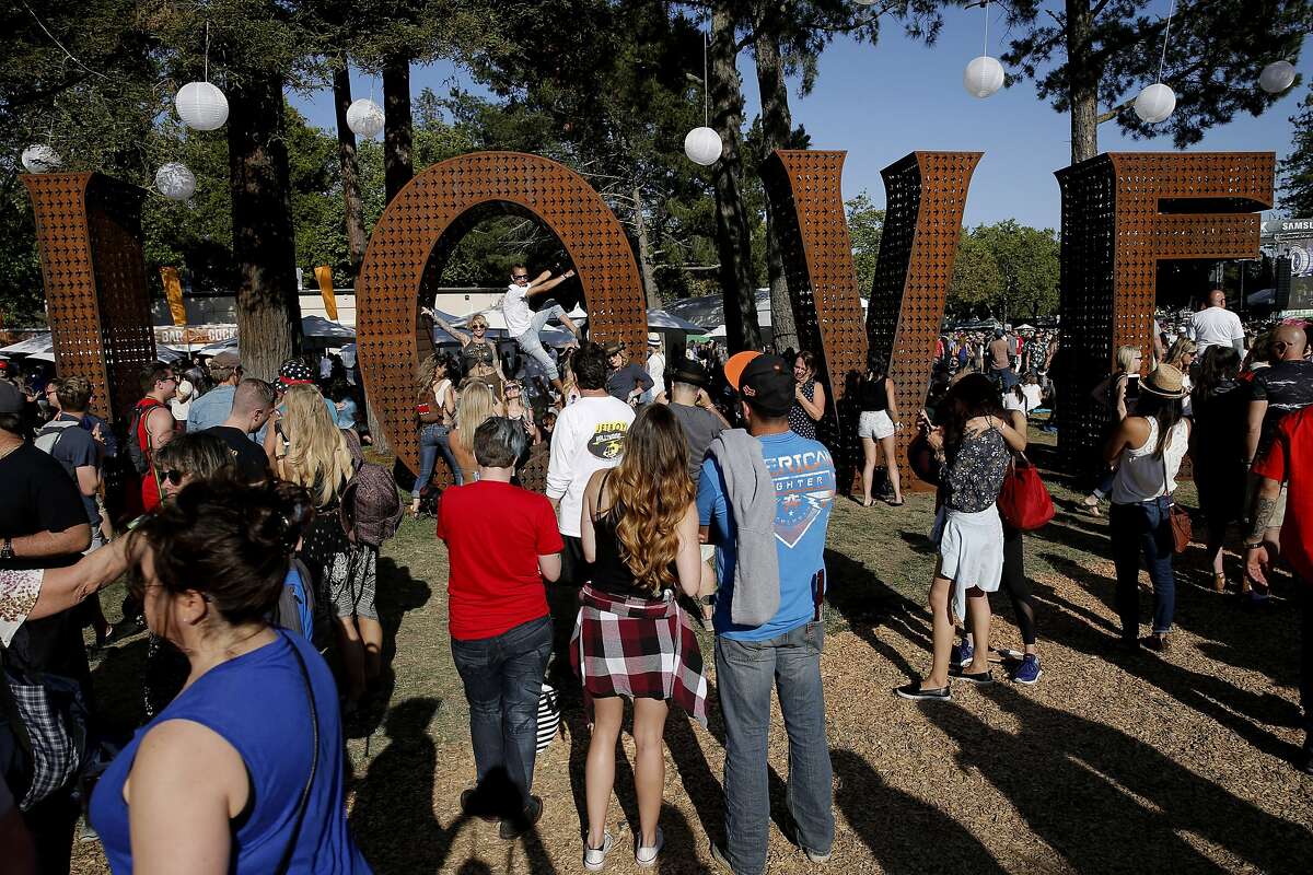 Festival-goers are seen checking out Laura Kimpton's LOVE sculpture during BottleRock on Saturday, May 27, 2017, in Napa, Calif.