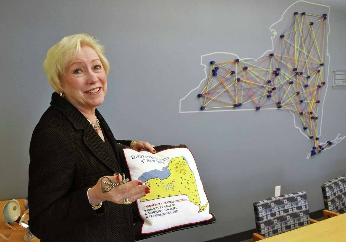 SUNY Chancellor Nancy Zimpher with a needlepoint pillow and a string art map both showing all 64 SUNYcampuses in her office Thursday May 25, 2017 in Albany, NY. (John Carl D'Annibale / Times Union)