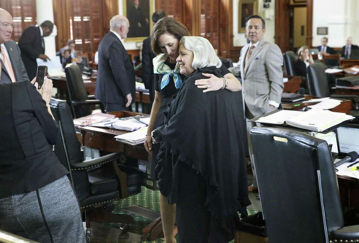 Senator Judith Zaffirini, D-Laredo, gets a hug from Senator Lois Kolkhorst, R-Brenham, after she wins passage in the Senate of her bill to ban texting while driving as legislators work at the Texas Capitol on May 19, 2017.