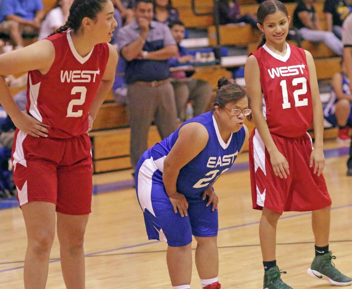 Martin's Stephanie Rico, center, a senior with Down syndrome, impressed at the 16th annual Bosom Buddies All-Star game last weekend. Rico got the start and scored four points in the East's 65-59 victory.