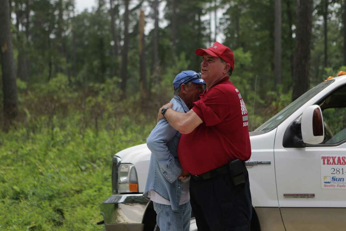 Rescuers Steve Degner, right, and Tim Miller, left, hugged relieved and happy that Ezra, the three-year-old child that went missing at the Sam Houston National Park was found, Sunday, May 28, 2017, in Waverly. ( Marie D. De Jesus / Houston Chronicle )