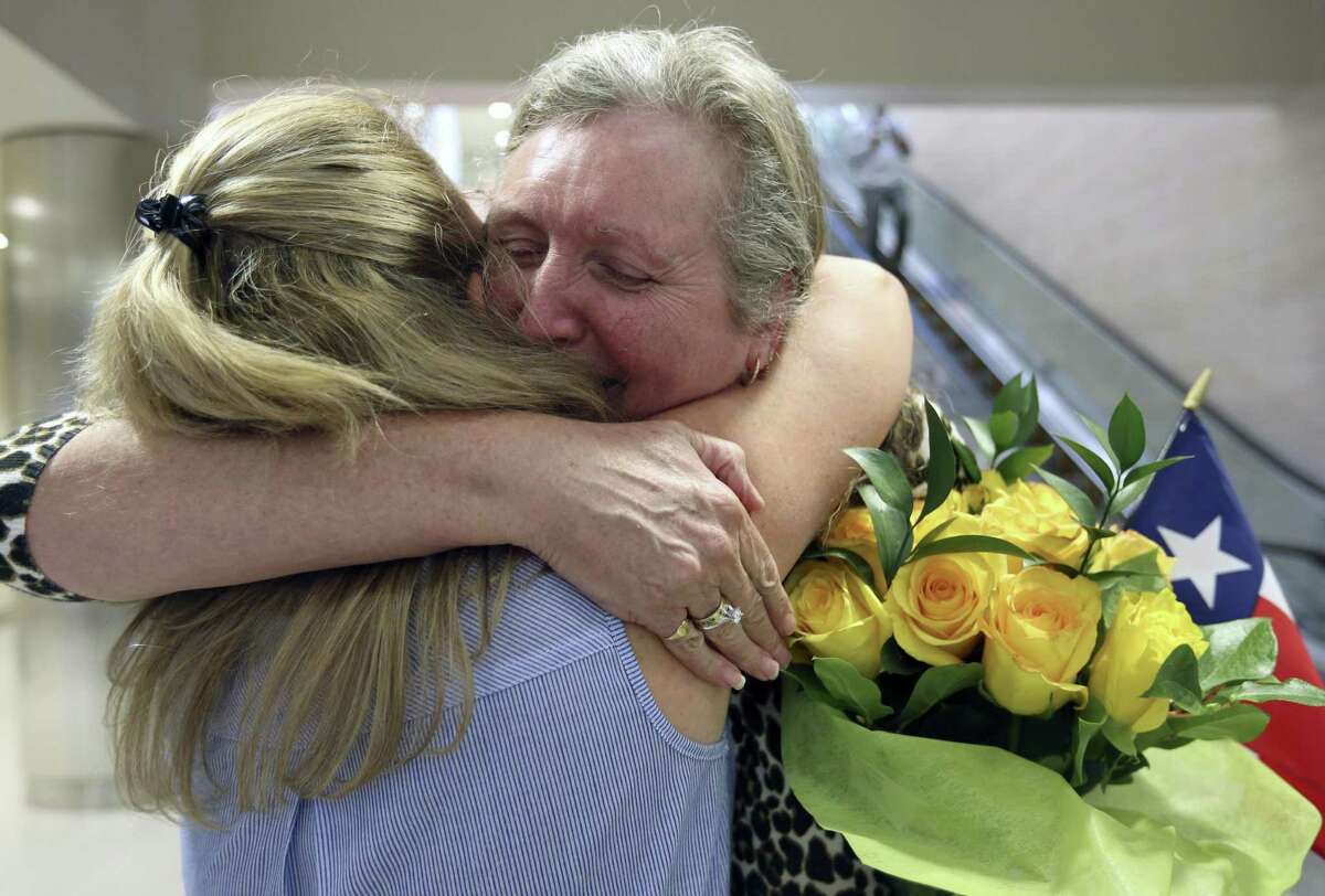 Jackie Rutter, facing camera, of London, hugs her San Antonio pen pal of almost 50 years, Casey Gray, as they meet Thursday, May 25, 2017 at the San Antonio International Airport for the first time.