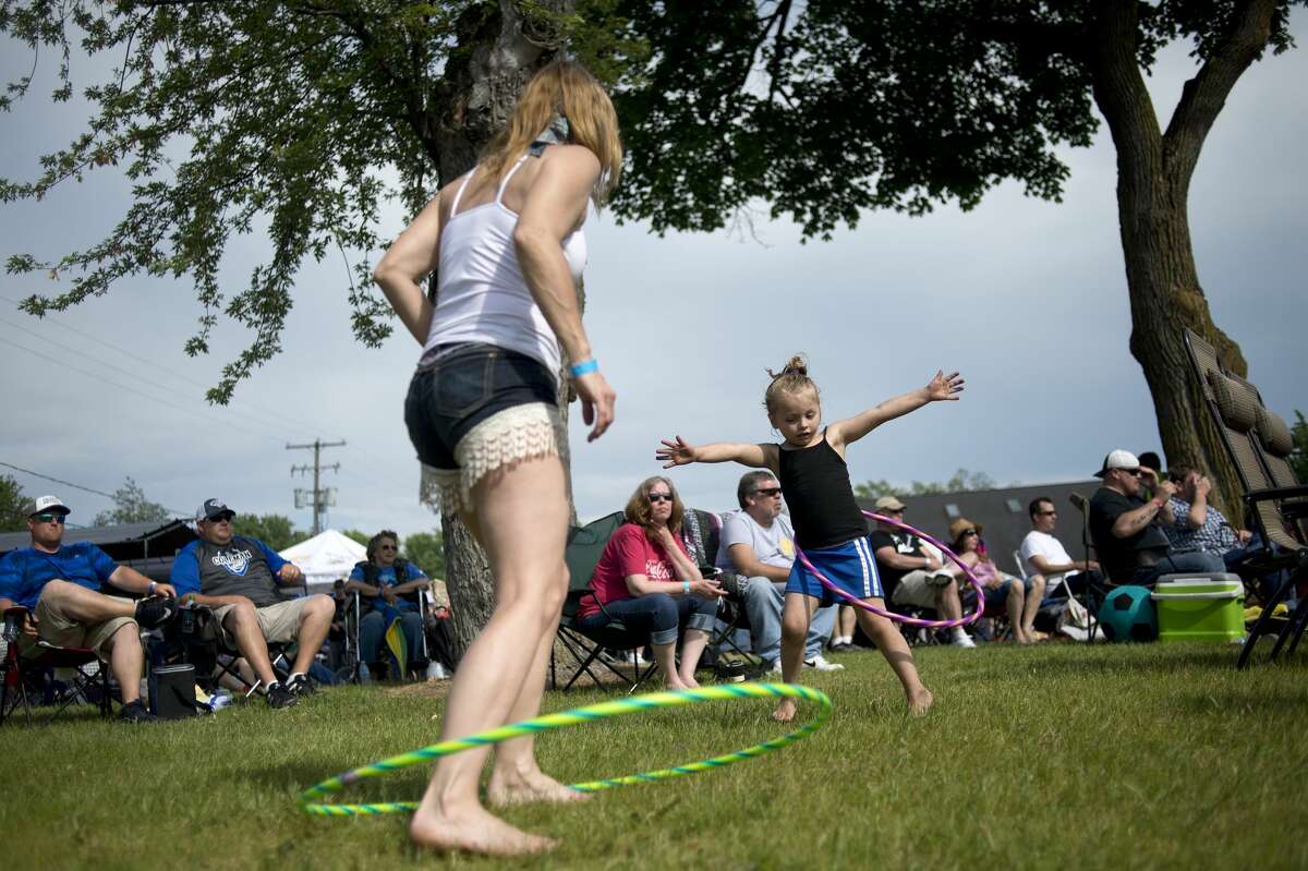 Brenda Blain, left, hula hoops with her granddaughter Alice Blain, 4, both of Lake, during the 7th annual "United by Sacrifice" concert presented by Coleman Veterans Memorial Sunday afternoon. The Sinclairs Band, Jedi Mind Trip and The Rock Show performed all afternoon before headliner Eddie Money hit the stage.
